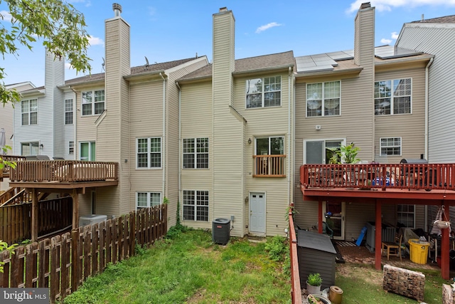 2204 Commissary Cir, Odenton, MD 21113 - rear view of property with central AC unit, solar panels, and a deck