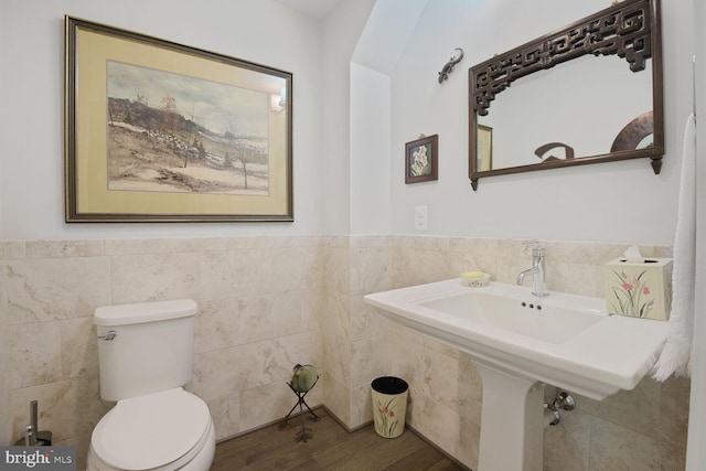 1516 16th Ct N, Arlington, VA 22209 - bathroom with tile walls, toilet, a wainscoted wall, and wood finished floors