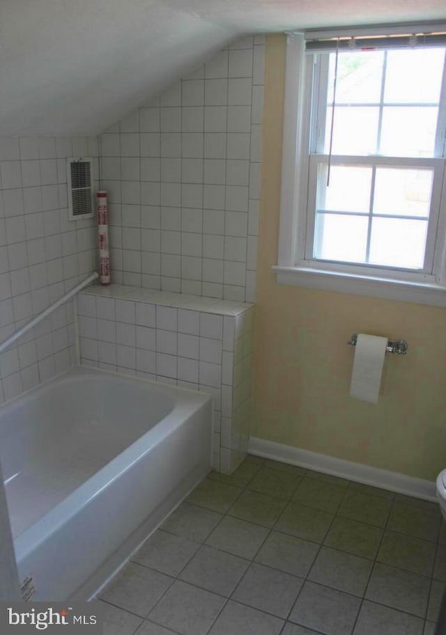 128 Fox Dr, Winchester, VA 22601 - full bathroom with lofted ceiling, tile patterned floors, a bath, toilet, and baseboards