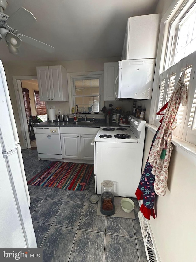 128 Fox Dr, Winchester, VA 22601 - kitchen with white appliances, white cabinets, a sink, and dark countertops