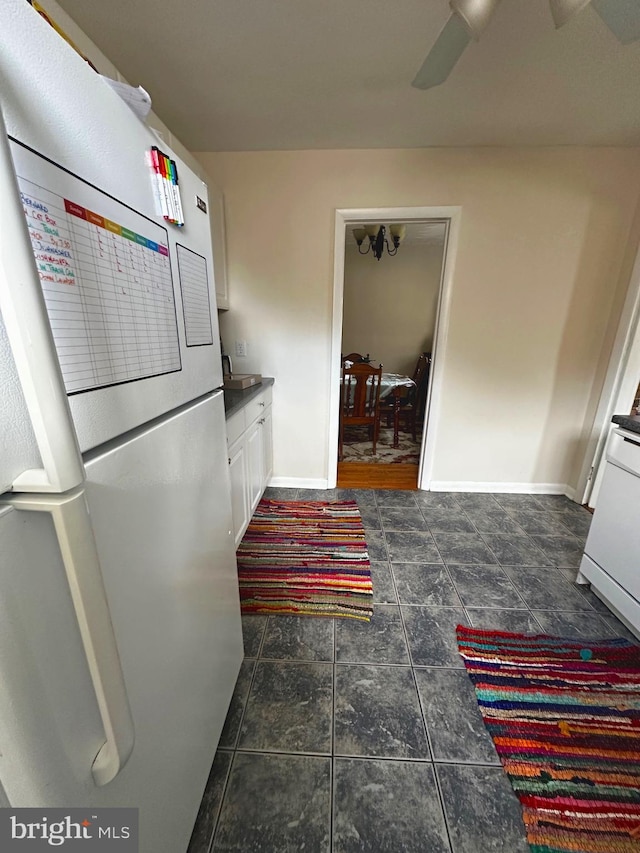 128 Fox Dr, Winchester, VA 22601 - kitchen featuring freestanding refrigerator, white cabinetry, baseboards, and ceiling fan