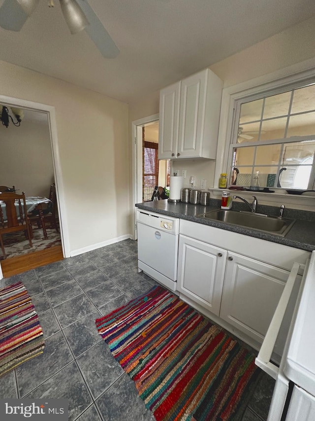 128 Fox Dr, Winchester, VA 22601 - kitchen with white dishwasher, a sink, white cabinetry, and dark countertops