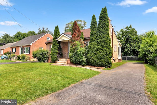 128 Fox Dr, Winchester, VA 22601 - view of front of home with driveway, brick siding, and a chimney
