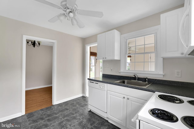128 Fox Dr, Winchester, VA 22601 - kitchen with white appliances, a sink, dark countertops, and white cabinets