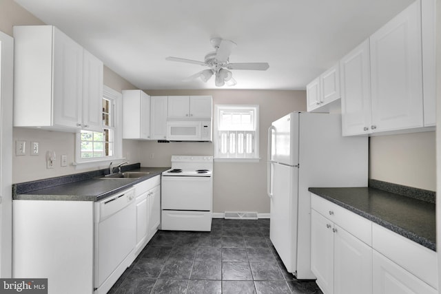 128 Fox Dr, Winchester, VA 22601 - kitchen with white appliances, dark countertops, white cabinets, a ceiling fan, and a sink