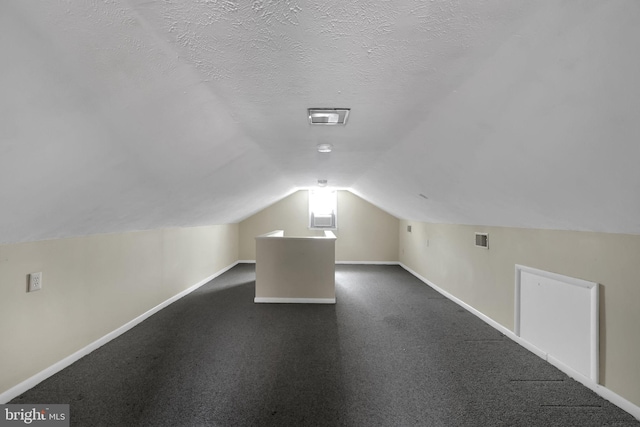 128 Fox Dr, Winchester, VA 22601 - bonus room with baseboards, vaulted ceiling, and a textured ceiling