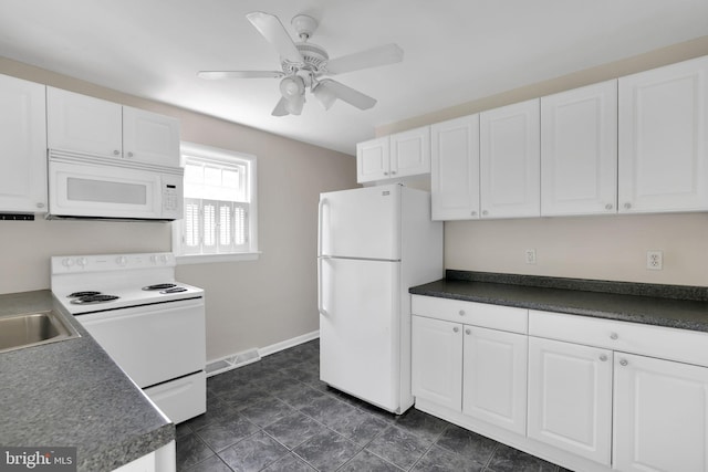 128 Fox Dr, Winchester, VA 22601 - kitchen featuring white appliances, white cabinets, and dark countertops