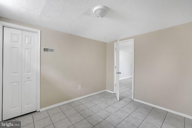 128 Fox Dr, Winchester, VA 22601 - empty room with light tile patterned flooring, a textured ceiling, and baseboards