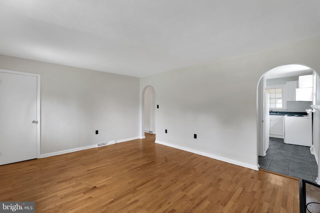 128 Fox Dr, Winchester, VA 22601 - spare room featuring arched walkways, light wood-style floors, and baseboards