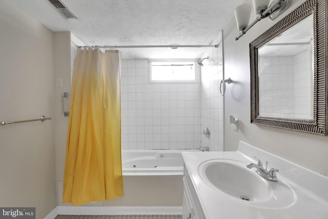 128 Fox Dr, Winchester, VA 22601 - bathroom with a combined bath / shower with jetted tub, vanity, and a textured ceiling