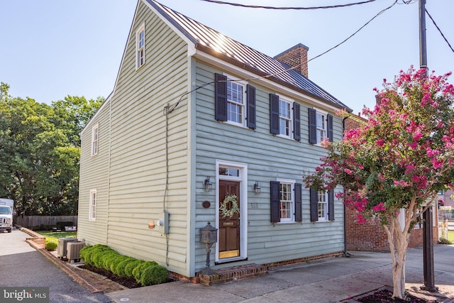 513 Princess Anne St, Fredericksburg, VA 22401 - colonial house with cooling unit, fence, metal roof, and a standing seam roof
