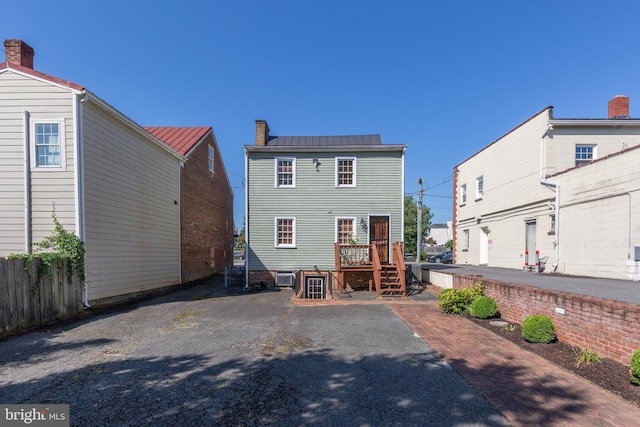 513 Princess Anne St, Fredericksburg, VA 22401 - back of property with a standing seam roof, a chimney, a deck, and metal roof