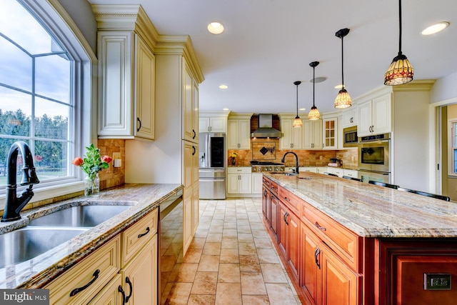 kitchen with wall chimney exhaust hood, a sink, stainless steel appliances, tasteful backsplash, and recessed lighting