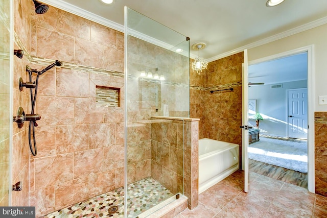 ensuite bathroom with ornamental molding, tiled shower, and a garden tub