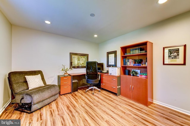 office area with light wood finished floors, recessed lighting, and baseboards