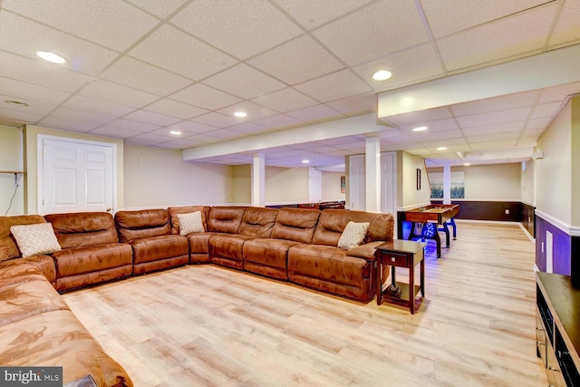 living area with wood finished floors, a paneled ceiling, recessed lighting, and a wainscoted wall