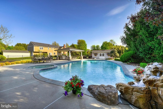view of pool featuring fence, an outbuilding, a patio area, an exterior structure, and a gazebo