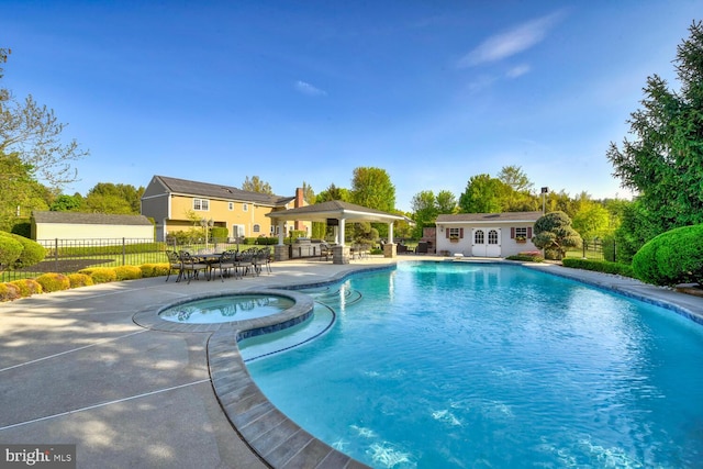 view of pool featuring a gazebo, a patio area, an outdoor structure, a storage structure, and fence