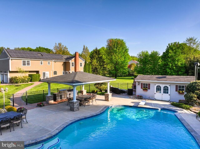 view of swimming pool featuring a storage structure, a patio, a gazebo, and an outdoor structure