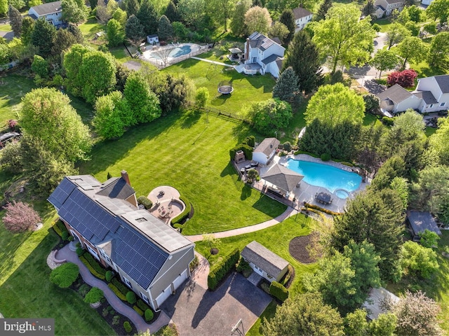 aerial view of property and surrounding area with a pool area