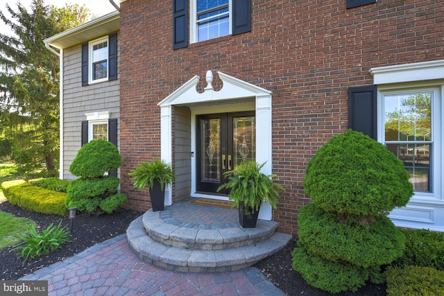 entrance to property featuring brick siding