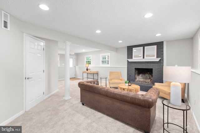 carpeted living area with baseboards, a brick fireplace, recessed lighting, and visible vents