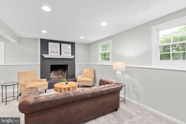 carpeted living area featuring a brick fireplace, recessed lighting, baseboards, and a textured ceiling