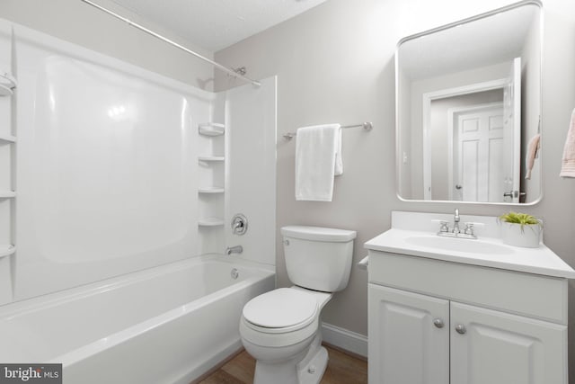 bathroom with vanity, wood finished floors, toilet, baseboards, and shower / tub combination