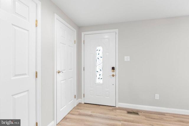 entrance foyer featuring light wood-style floors, baseboards, and visible vents
