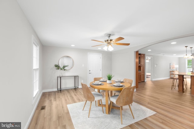 dining area featuring light wood-style floors, recessed lighting, baseboards, a ceiling fan, and visible vents
