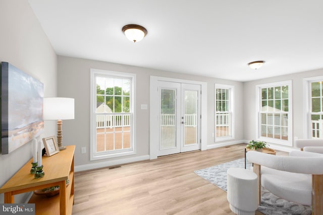 entryway with visible vents, light wood-style floors, baseboards, and french doors