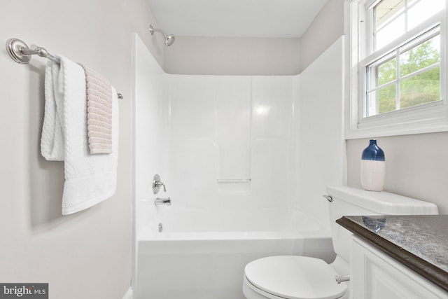 bathroom with vanity, shower / bathing tub combination, and toilet