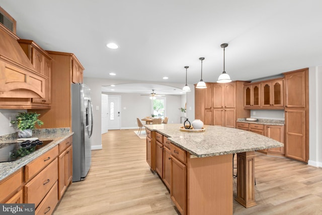 kitchen with freestanding refrigerator, a ceiling fan, baseboards, and black electric stovetop