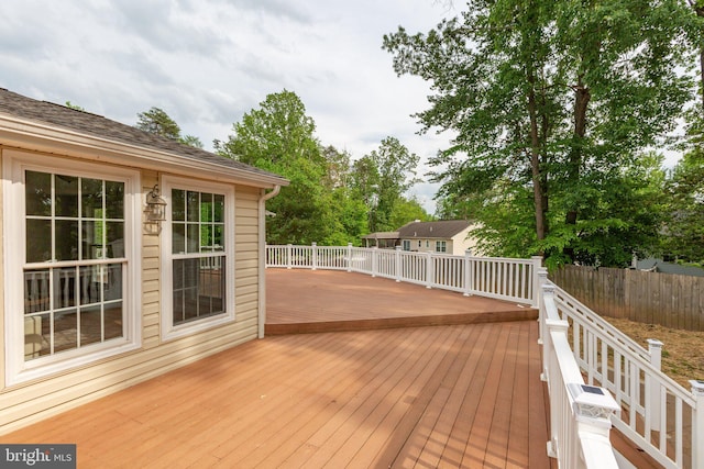 wooden terrace featuring fence