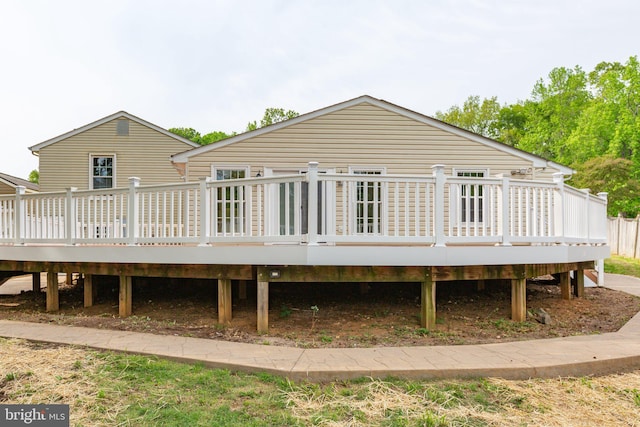 rear view of property featuring a wooden deck