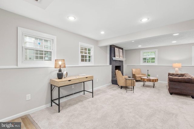 living area with baseboards, carpet, a brick fireplace, and recessed lighting