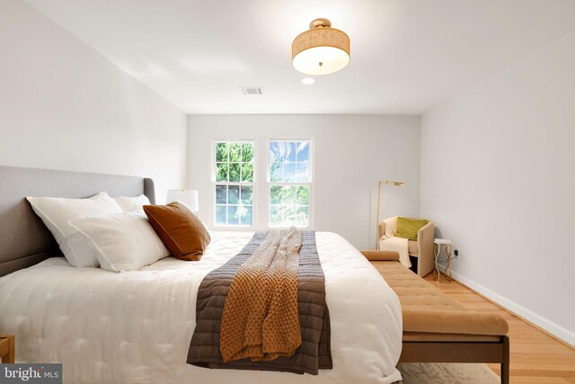 bedroom featuring wood finished floors and baseboards