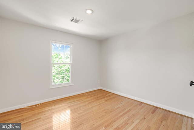 unfurnished room with baseboards, hardwood / wood-style floors, and recessed lighting