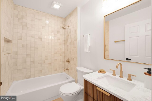 bathroom with toilet, bathtub / shower combination, and vanity