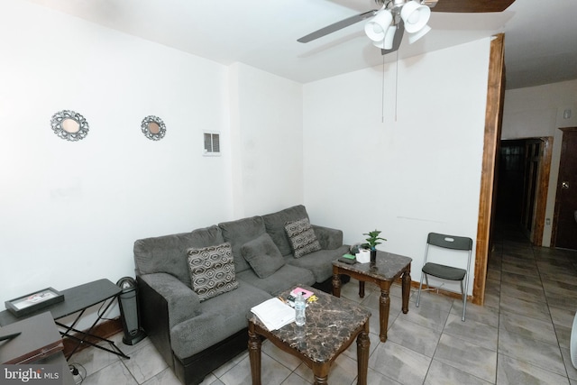 living room with a ceiling fan and light tile patterned floors