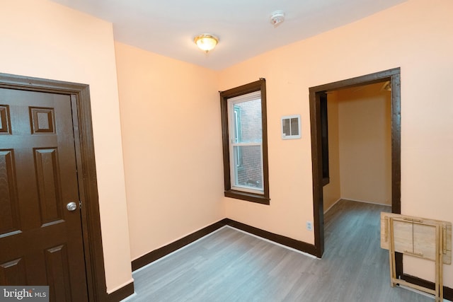 hall with wood finished floors and baseboards