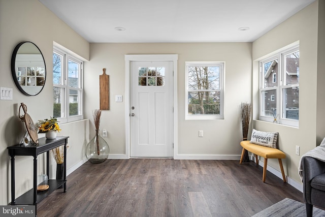 entrance foyer featuring baseboards and dark wood-style flooring
