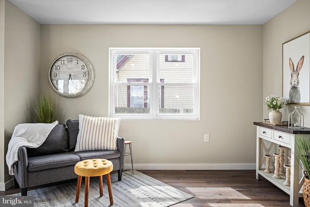 sitting room with baseboards and wood finished floors