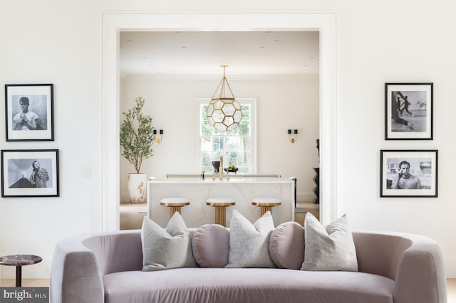 living area featuring baseboards and ornamental molding