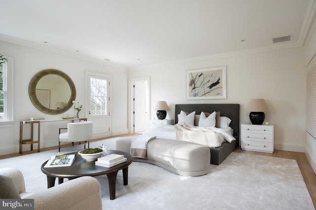 bedroom with baseboards, visible vents, and ornamental molding