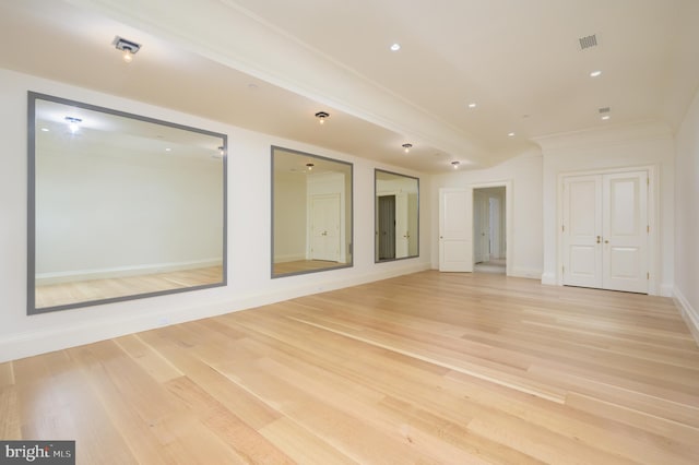 empty room featuring visible vents, crown molding, baseboards, light wood finished floors, and recessed lighting