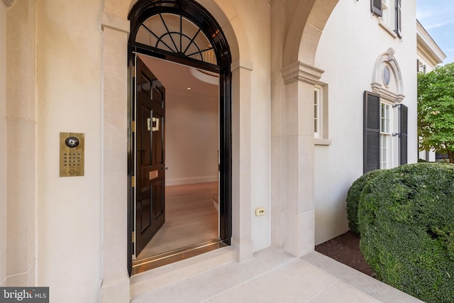 property entrance with stucco siding