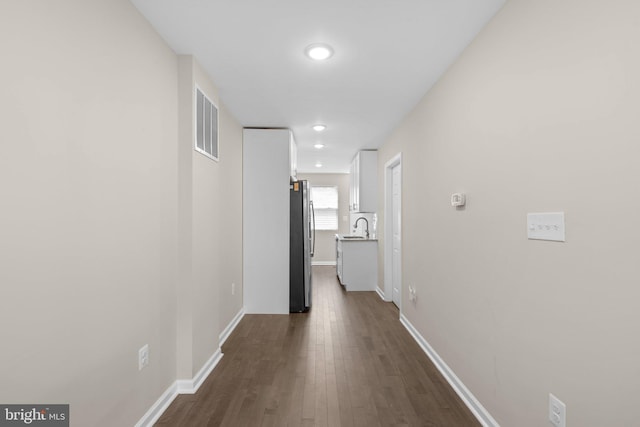 1414 N Bethel St, Baltimore, MD 21213 - corridor with a sink, baseboards, dark wood finished floors, and recessed lighting