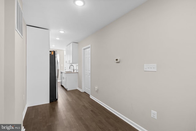 1414 N Bethel St, Baltimore, MD 21213 - corridor featuring a sink, recessed lighting, dark wood-style floors, and baseboards