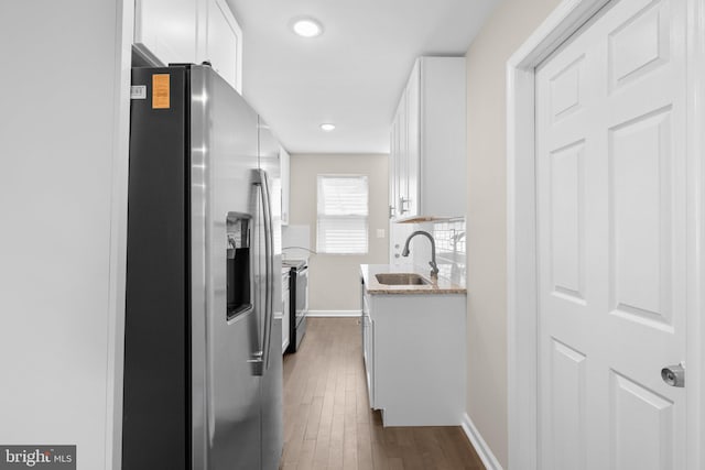 1414 N Bethel St, Baltimore, MD 21213 - kitchen featuring stainless steel refrigerator with ice dispenser, a sink, electric stove, white cabinets, and baseboards
